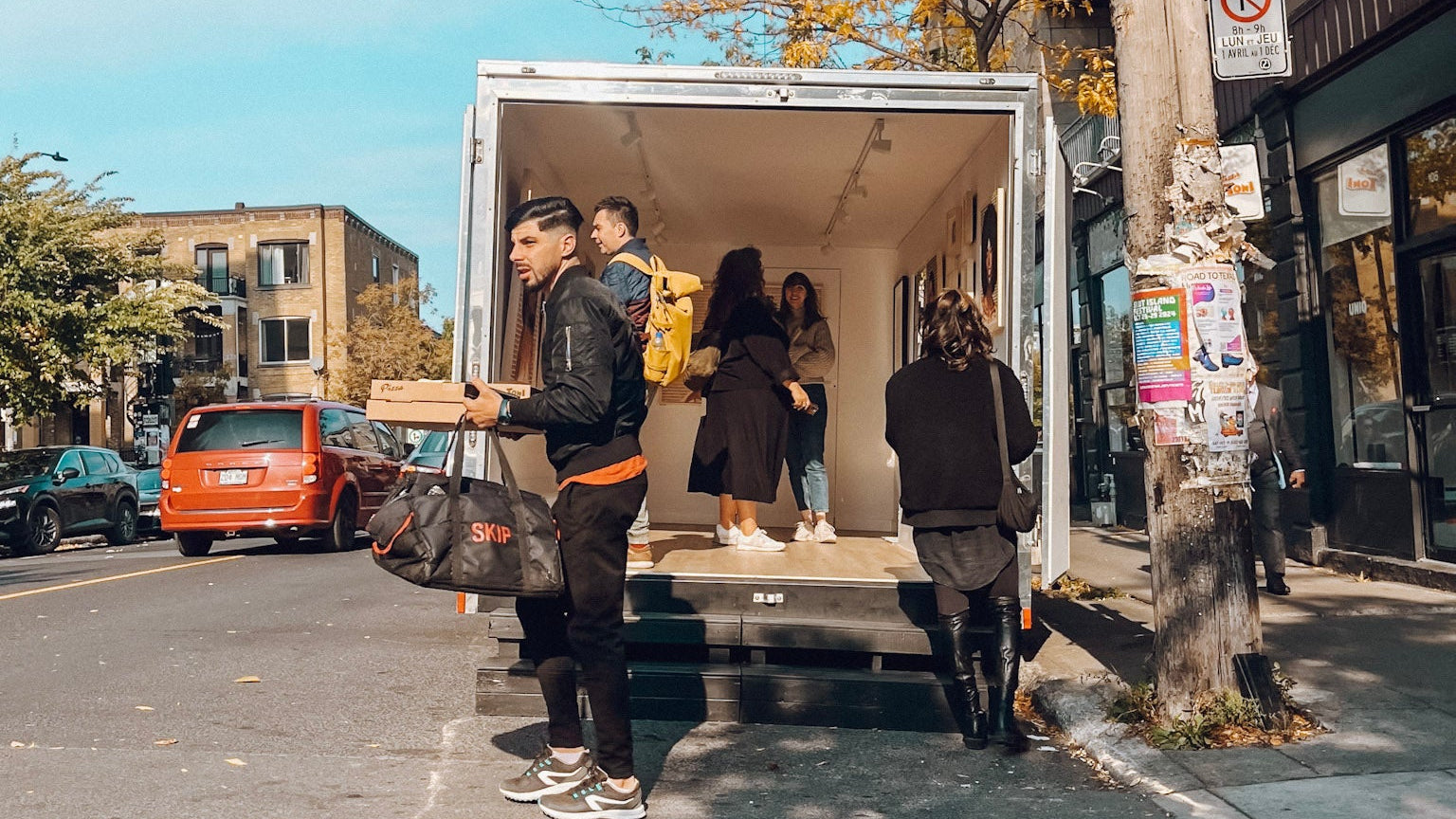 People admiring art in the mobile gallery on a city street