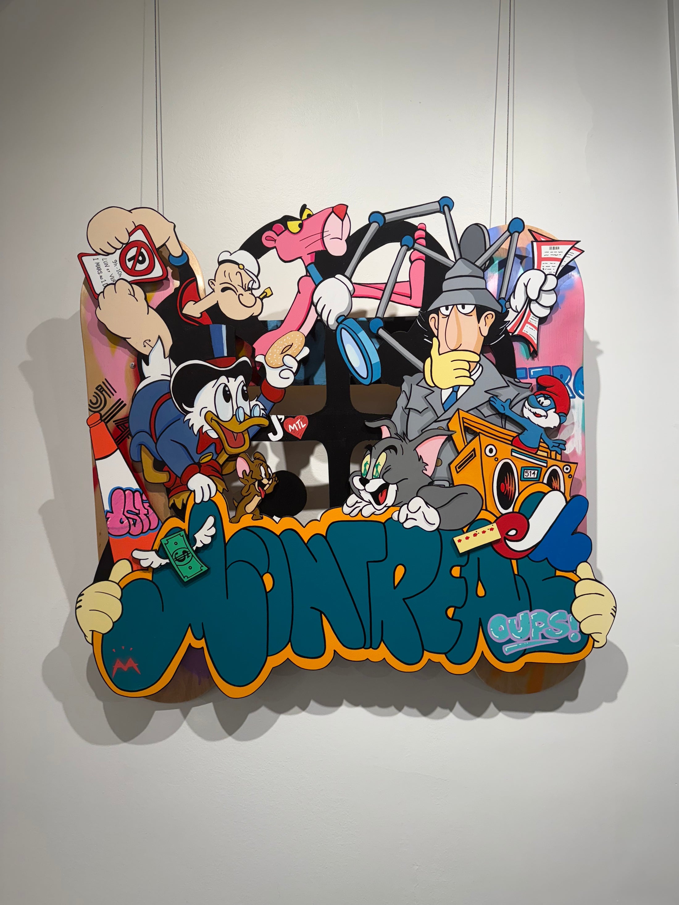 Mixed media artwork titled “Made in MTL” by MA Art created on two skateboards, featuring urban-inspired contemporary design with layered textures and bold graphic elements.